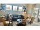 Comfortable living room featuring large windows, a plush sofa, stylish chairs and tasteful decor at 9471 Ashbury Cir # 202, Parker, CO 80134