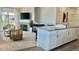 Well-lit living room open to kitchen with fireplace, stylish chairs and decor at 9471 Ashbury Cir # 202, Parker, CO 80134