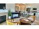 Bright living room with a modern fireplace and stylish decor open to kitchen with granite countertops and breakfast bar seating at 9471 Ashbury Cir # 202, Parker, CO 80134