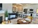 Bright living room with a modern fireplace and stylish decor open to kitchen with granite countertops and breakfast bar seating at 9471 Ashbury Cir # 202, Parker, CO 80134