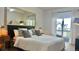 Serene bedroom with a large bed, stylish lamps, and a private balcony with lovely views at 9471 Ashbury Cir # 202, Parker, CO 80134