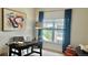 Comfortable home office with a dark wood desk, stylish decor, and great natural light at 9471 Ashbury Cir # 202, Parker, CO 80134