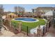 Community pool and seating area surrounded by well-maintained landscaping at 9471 Ashbury Cir # 202, Parker, CO 80134