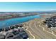 Stunning aerial view of a community near a beautiful lake with mountain views in the background at 4863 River Landing Ave, Firestone, CO 80504