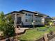 Backyard featuring a modern house with mature trees and a volleyball net at 4863 River Landing Ave, Firestone, CO 80504