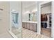 Beautiful bathroom with glass shower, double vanity and walk-in closet at 4863 River Landing Ave, Firestone, CO 80504