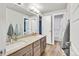 Bathroom with double sinks and view into a bedroom with an ensuite bathroom at 4863 River Landing Ave, Firestone, CO 80504