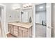Bathroom featuring double sinks with granite vanity and open view to the basement bedroom at 4863 River Landing Ave, Firestone, CO 80504