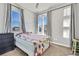 Bright bedroom featuring large windows, neutral carpet, and ample natural light at 4863 River Landing Ave, Firestone, CO 80504