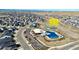 Aerial view of the Cove community pool and gym with tennis courts for recreation at 4863 River Landing Ave, Firestone, CO 80504