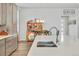 Open dining area next to kitchen island featuring dining room table set and colorful display case at 4863 River Landing Ave, Firestone, CO 80504