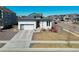Modern home showcasing a well-kept front yard, a gray garage door, and neutral tones at 4863 River Landing Ave, Firestone, CO 80504