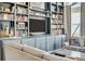 Cozy living room with a large flat screen television and custom built-in shelving at 4863 River Landing Ave, Firestone, CO 80504