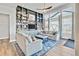 Bright living room with built-in bookcase, large windows, and wood floors at 4863 River Landing Ave, Firestone, CO 80504