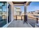 Covered front porch with grill and view of neighborhood at 4863 River Landing Ave, Firestone, CO 80504
