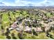 Overhead view of the property and neighborhood with golf course and mountain views at 3930 S Pinehurst Cir, Denver, CO 80235