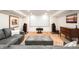 Finished basement featuring a large screen projector, speakers, sofa, and stylish decor at 3930 S Pinehurst Cir, Denver, CO 80235