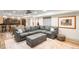Spacious basement featuring a large comfortable sectional, guitars on the wall, and a bar area at 3930 S Pinehurst Cir, Denver, CO 80235
