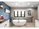 Luxurious bathroom with a freestanding tub, stylish fixtures, and elegant decor at 3930 S Pinehurst Cir, Denver, CO 80235