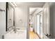 Elegant bathroom featuring a modern vanity with quartz countertop and access to a screened porch at 3930 S Pinehurst Cir, Denver, CO 80235