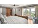 Bedroom with a unique wood door, golf course views, a ceiling fan, and a luxurious sleigh bed at 3930 S Pinehurst Cir, Denver, CO 80235