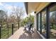 Outdoor deck area with two Adirondack chairs and views of trees and a lawn at 3930 S Pinehurst Cir, Denver, CO 80235