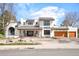 Stunning contemporary home with a well-manicured lawn, beautiful landscaping, and a welcoming entrance at 3930 S Pinehurst Cir, Denver, CO 80235