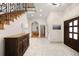 Elegant foyer with beautiful flooring, decorative staircase, and plenty of natural light at 3930 S Pinehurst Cir, Denver, CO 80235