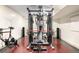 Well-equipped home gym with weight machines, exercise bike, and free weights at 3930 S Pinehurst Cir, Denver, CO 80235
