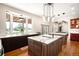 Spacious kitchen featuring marble countertops, modern lighting, and a large window overlooking the outdoor area at 3930 S Pinehurst Cir, Denver, CO 80235