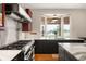Bright kitchen featuring granite countertops, stainless steel appliances, and a scenic window view at 3930 S Pinehurst Cir, Denver, CO 80235