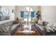 Elegant living room with hardwood floors, stylish sofas, bright curtains, and an open airy layout at 3930 S Pinehurst Cir, Denver, CO 80235