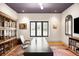 Well-appointed office space with custom built-ins, hardwood floors, and ample natural light from the window at 3930 S Pinehurst Cir, Denver, CO 80235