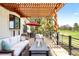 Charming outdoor patio with comfortable seating, a fire pit, and a pergola, perfect for entertaining at 3930 S Pinehurst Cir, Denver, CO 80235