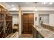 Finished basement bar area with a large wine cellar, a beer tap, and granite countertops at 3930 S Pinehurst Cir, Denver, CO 80235