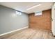 Finished basement featuring hardwood flooring and two windows providing natural light at 7770 Kenwood St, Commerce City, CO 80022