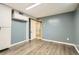 Finished basement featuring hardwood flooring and access to other rooms at 7770 Kenwood St, Commerce City, CO 80022