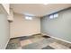 Finished basement featuring tiled flooring and two window providing natural light at 7770 Kenwood St, Commerce City, CO 80022