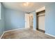 Light blue bedroom with plush carpets and a closet at 7770 Kenwood St, Commerce City, CO 80022