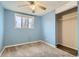 Light blue bedroom showcasing a window, carpeted floors and a convenient closet at 7770 Kenwood St, Commerce City, CO 80022