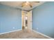 Light blue bedroom showing plush carpets and a open door looking into the hallway at 7770 Kenwood St, Commerce City, CO 80022