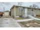 Charming home featuring a quaint front yard, long driveway, and single car detached garage at 7770 Kenwood St, Commerce City, CO 80022