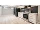View of basement kitchenette with stainless steel range and ample cabinet space at 7770 Kenwood St, Commerce City, CO 80022