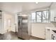 Kitchen featuring stainless steel appliances, ample counter space, and stylish flooring at 7770 Kenwood St, Commerce City, CO 80022