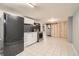 View of basement kitchenette with stainless steel range and full sized refrigerator at 7770 Kenwood St, Commerce City, CO 80022