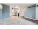 Bright open-concept living room featuring sleek flooring, a ceiling fan, and modern wall color at 7770 Kenwood St, Commerce City, CO 80022