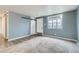 Bright living room featuring sleek flooring, a barn door, and modern wall color at 7770 Kenwood St, Commerce City, CO 80022