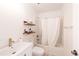Bathroom featuring a tub with shower head, toilet, and a vanity with a gold-toned faucet at 661 Snowberry St, Longmont, CO 80503