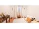 Well-lit bedroom featuring hardwood floors, white rug, and a window with white curtains at 661 Snowberry St, Longmont, CO 80503