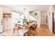 Stylish dining room featuring a large wooden table, contemporary decor, and hardwood floors at 661 Snowberry St, Longmont, CO 80503
